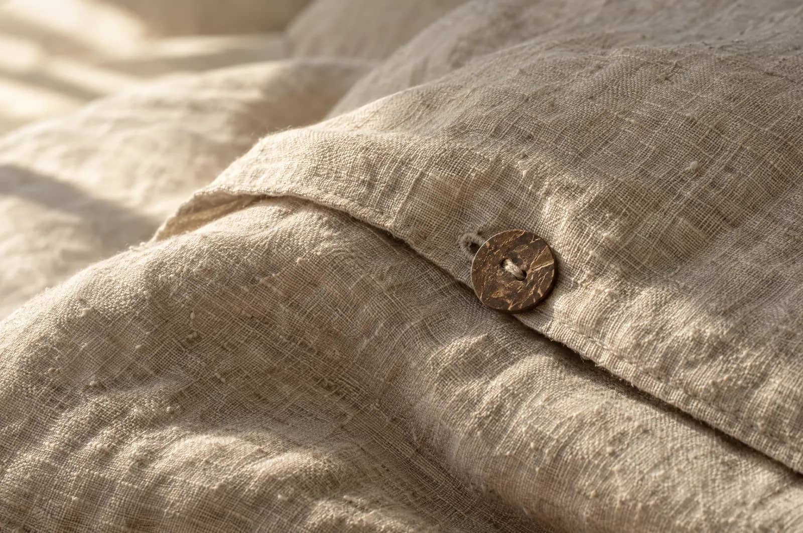 Close-up of stonewashed flax linen with a coconut-shell button